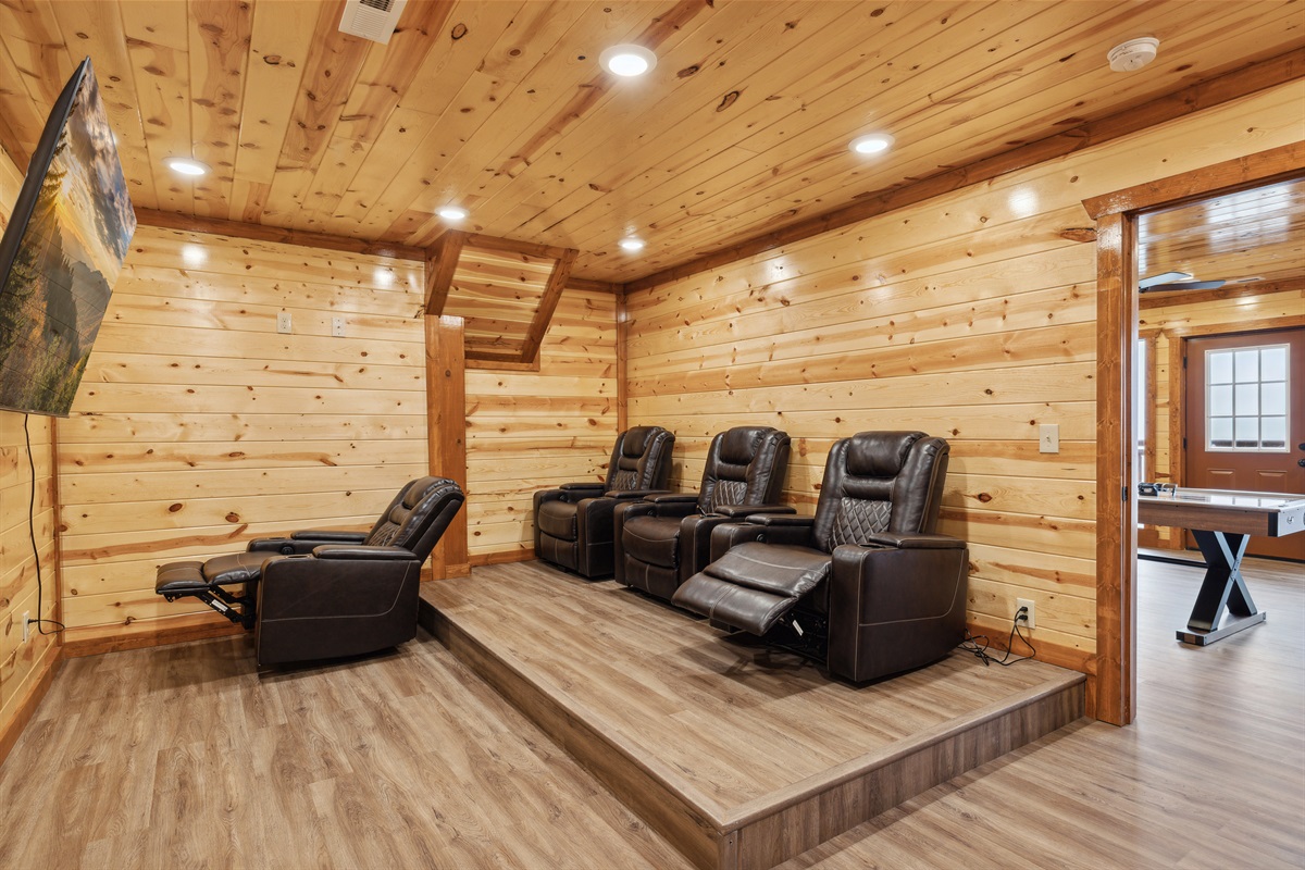 Private theater room with reclining cinema-style seating