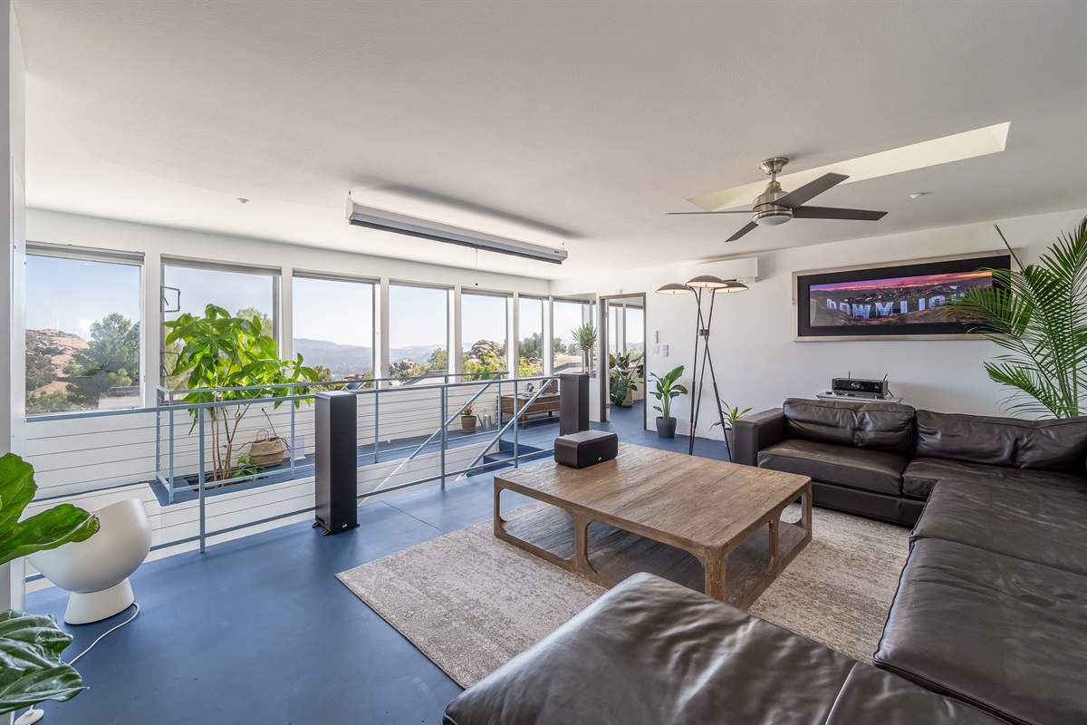 wraparound RH Leather sofa with RH coffee table and lighting and views