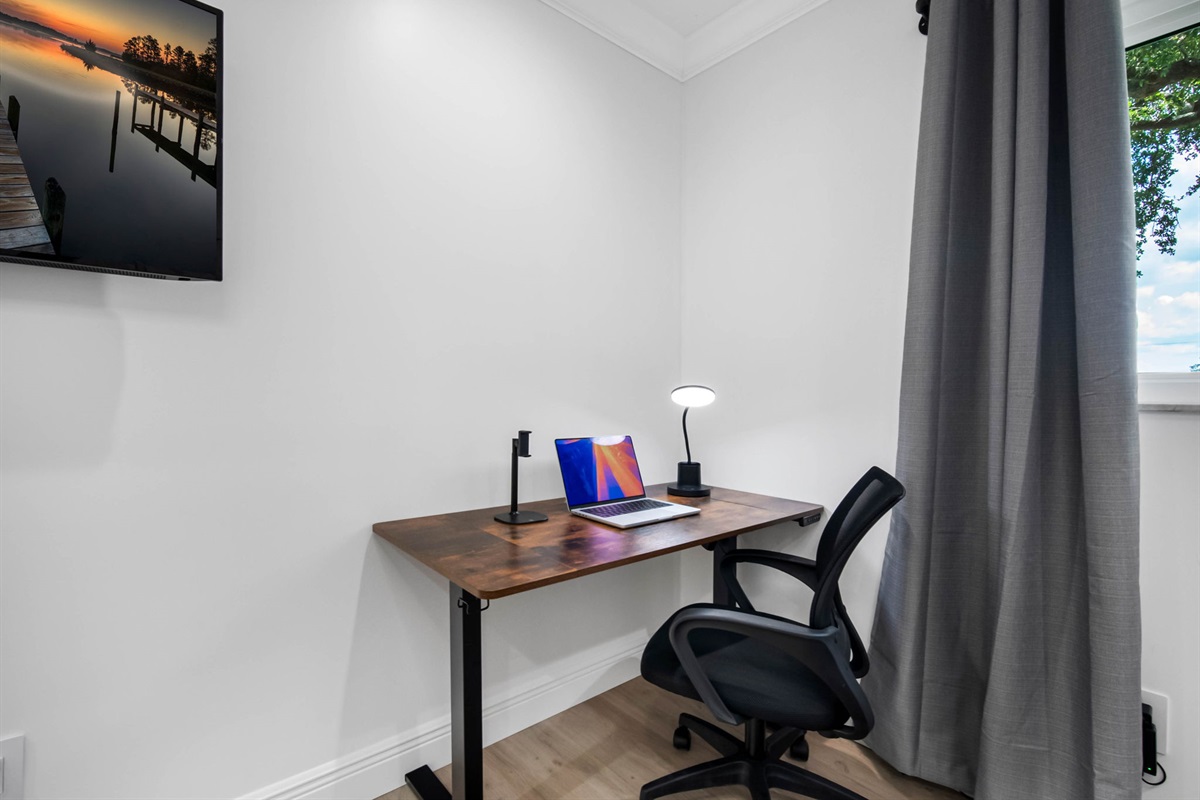 A dedicated workstation with an ergonomic chair makes this room perfect for digital nomads or remote professionals.