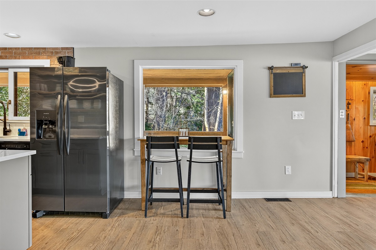 Bar seating and kitchen pass-through for casual meals.
