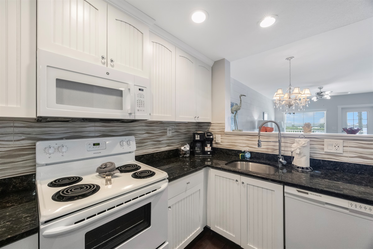 Kitchen fully stocked with cooking/eating/drinking utensils