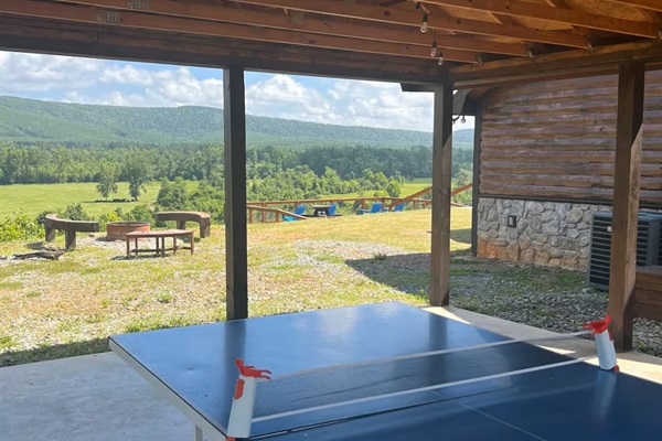 Ping pong table under the side covered patio with views of the property.