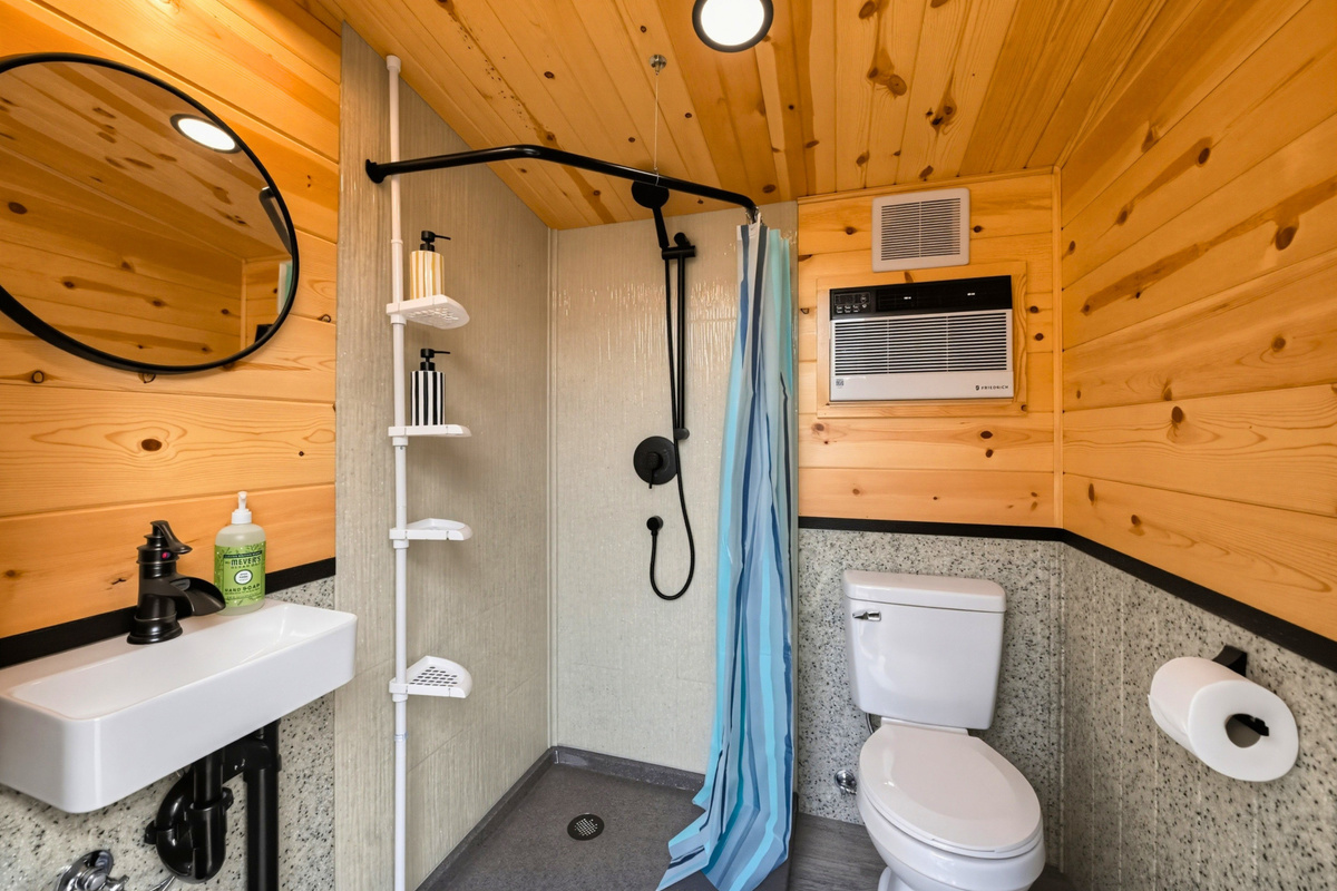 Freshen up in the full bathroom, complete with a shower, toilet, and sink.