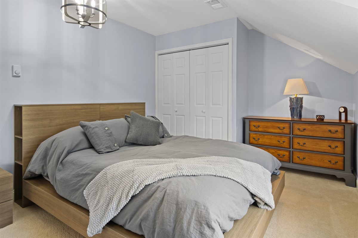 Queen bed with dresser and closet space