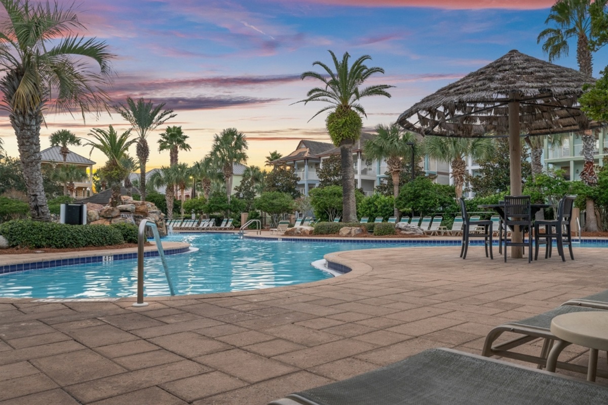 Golden hour at the resort pool, palms and all.
