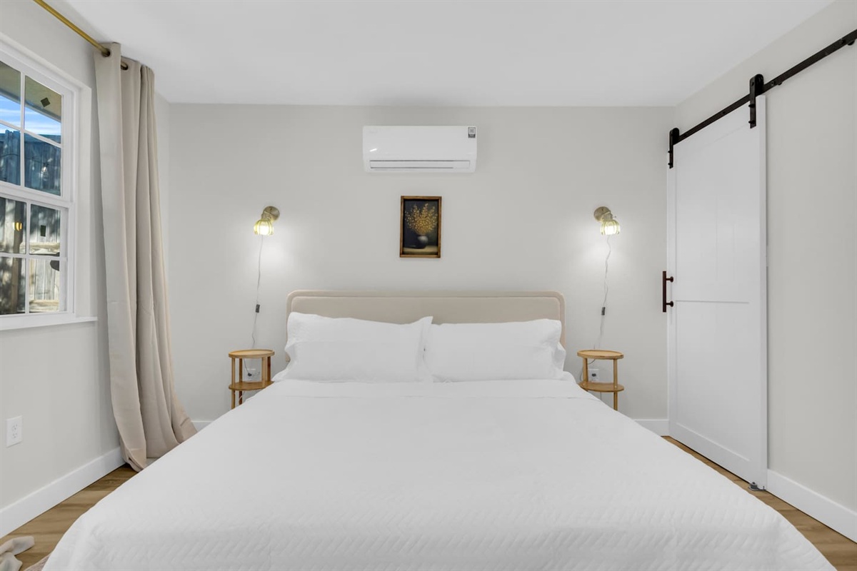 Enjoy a relaxing stay with a plush king bed, sliding barn door closet, and a fully stocked bathroom complete with a shower and Ginger Lily Farms essentials.
