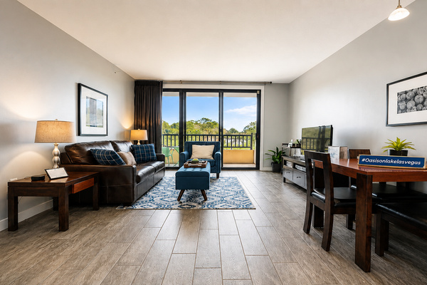 Unwind in the light-filled living room featuring floor-to-ceiling sliding doors with panoram lake and mountian views.