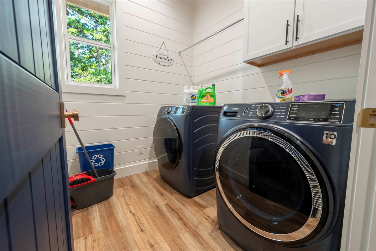 Convenient in-cabin laundry room with modern washer and dryer