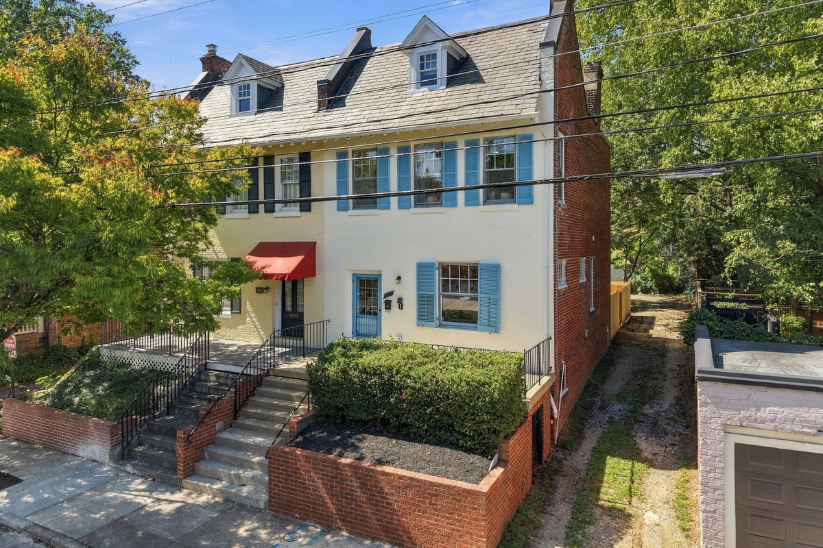 Exterior: Charming brick façade with vibrant blue shutters and inviting entryway awaits you!