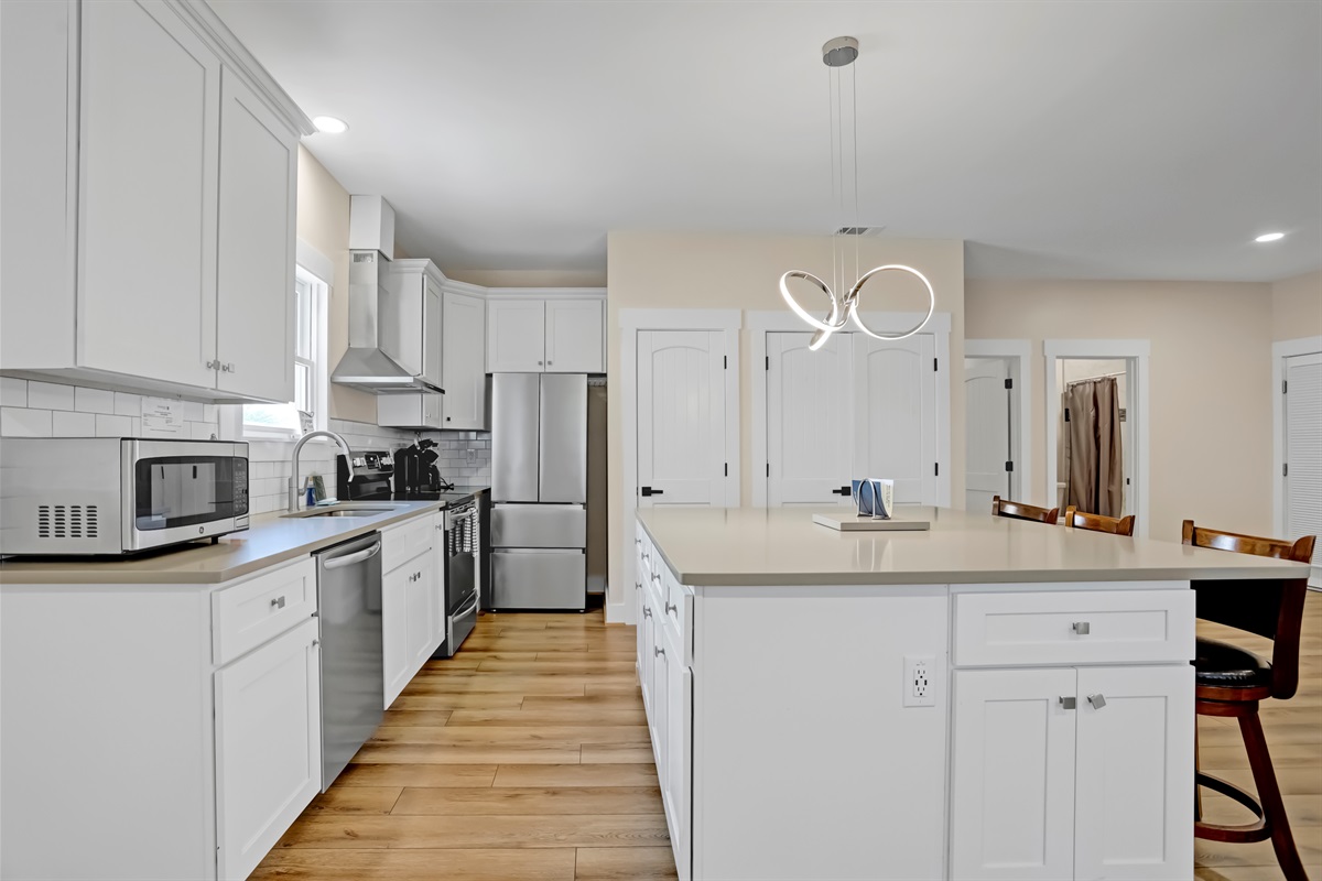 A spacious kitchen island offers plenty of room for cooking or casual dining.