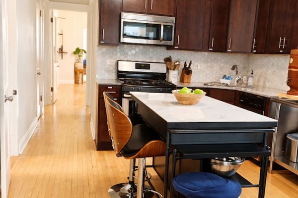 Kitchen island with bar seating fully stocked for cooking amazing meals.