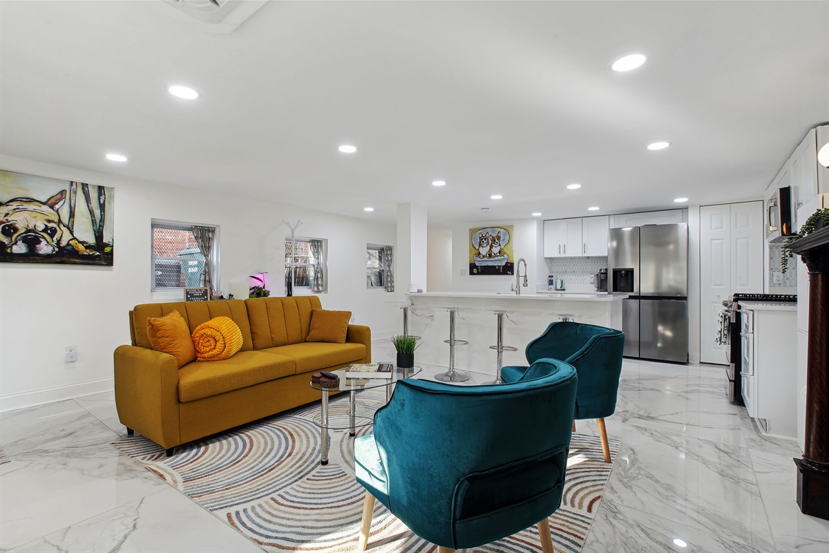 The living room in the lower level can comfortably sit five people and there are additionally four stools on the kitchen island as well