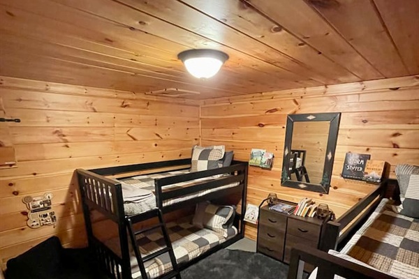 Basement bedroom with 2 bunkbeds, each with 2 twin beds (4 total twin beds) - great for kids! Includes kids' books, reading corner and wall sensory toy. 