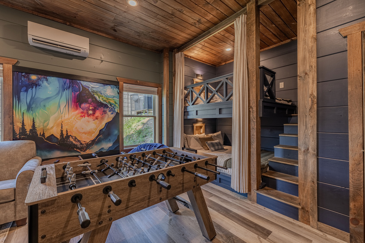 This cozy bunk room has a fun mural, foosball and incredible bunks.