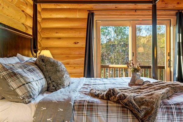 Spacious master suite featuring a king bed, TV, dresser, and private bath.