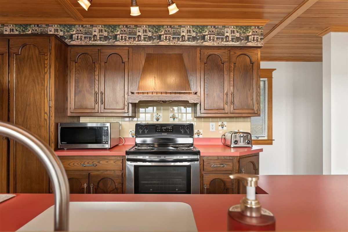 Fully equipped kitchen and coffee station with drip coffee maker, Keurig (K-cup), and tea setup—complete with spices, cookware, kid-friendly dishes, and beautiful tableware, making it easy to prepare anything from morning coffee to family meals