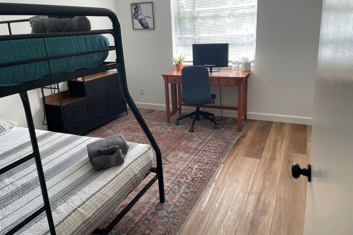 Comfortable workspace featuring a sleek desk and ergonomic office chair, perfect for productivity during your stay.