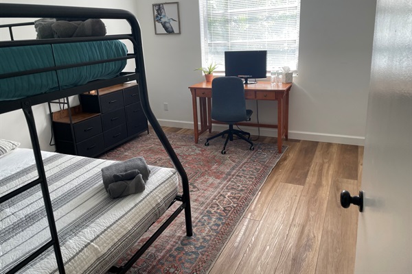 Comfortable workspace featuring a sleek desk and ergonomic office chair, perfect for productivity during your stay.