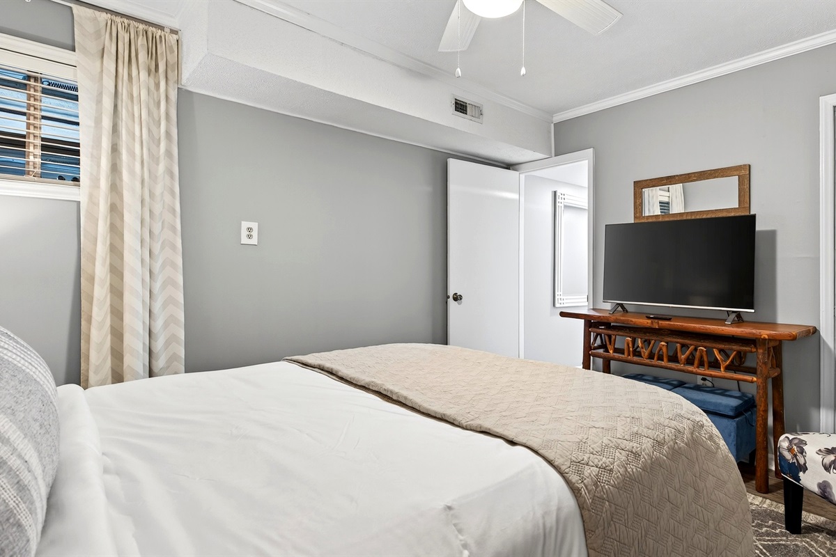Lower level bedroom features a TV.
