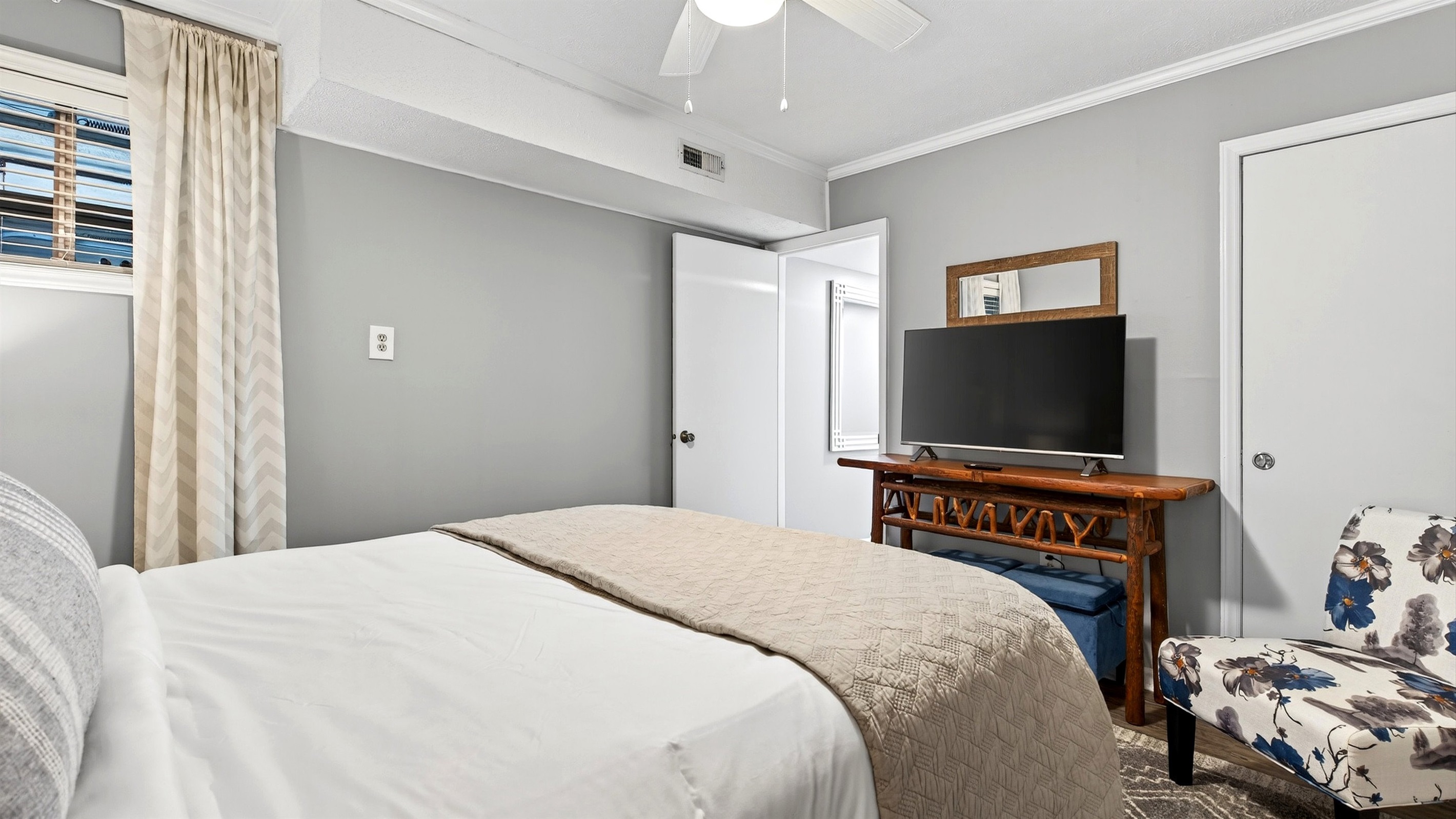 Lower level bedroom features a TV.