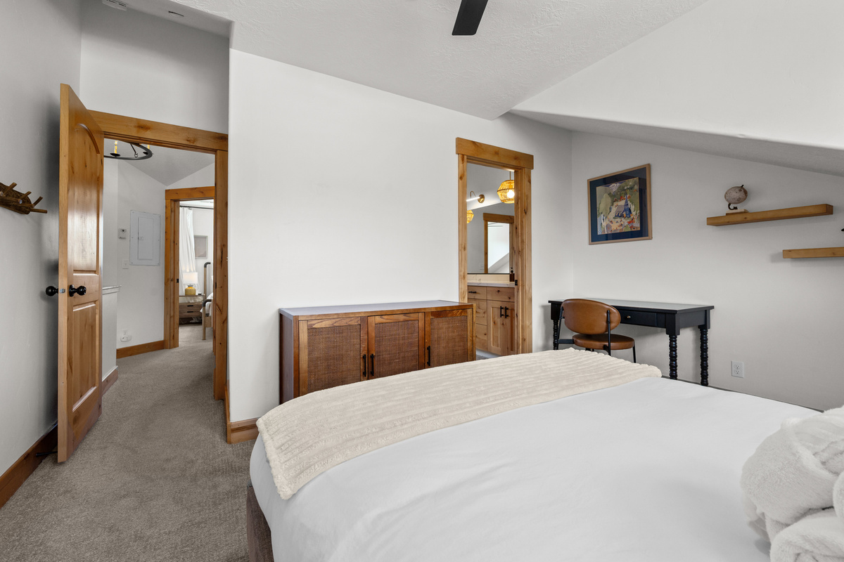The spacious bedroom blends mountain character with the comforts you want for a longer stay.