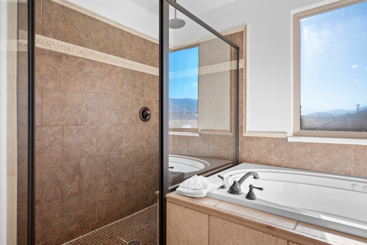 Enjoy dual sinks, a glass-enclosed shower, and a picture-perfect mountain view from the tub.