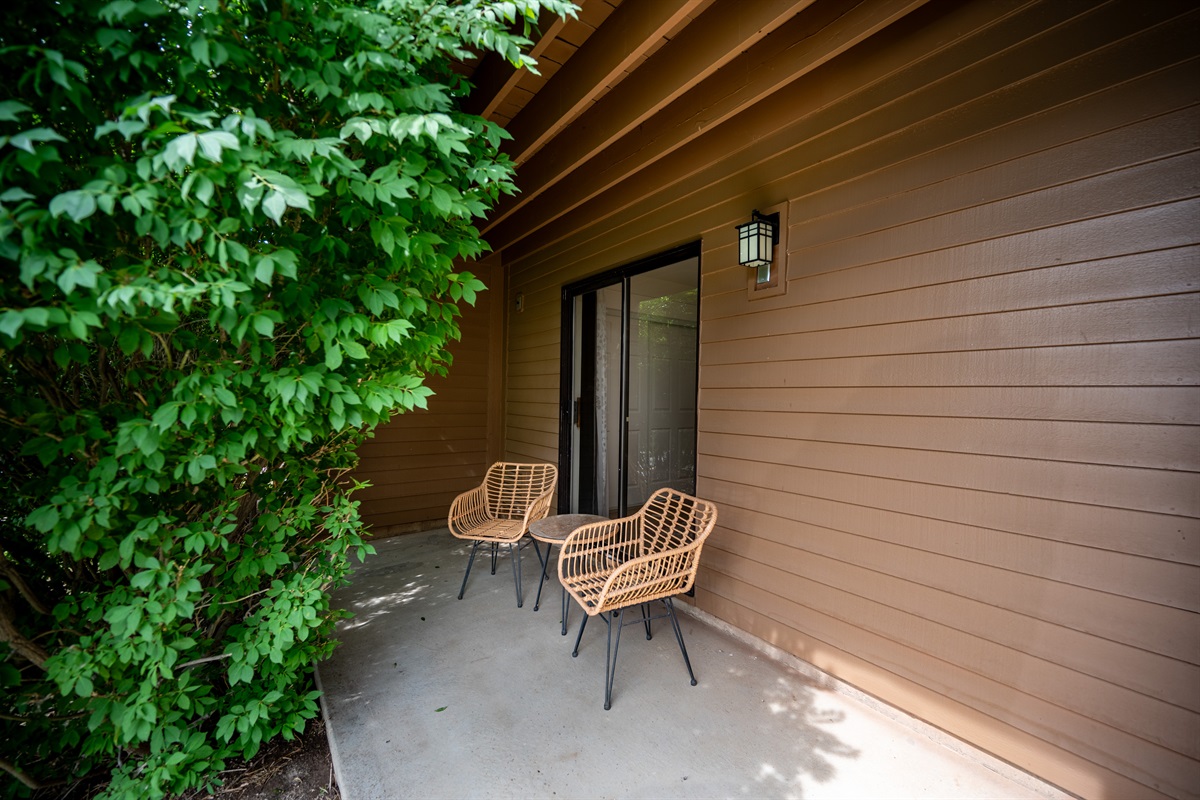 rivate patio with garden bushes providing a serene and tranquil atmosphere.