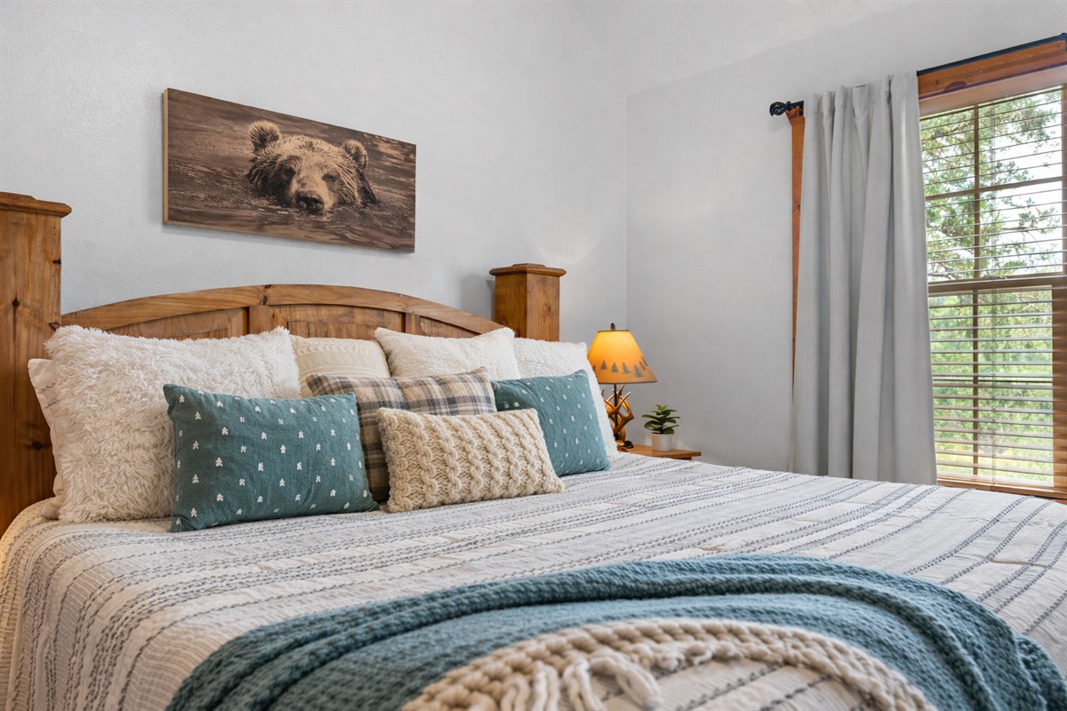 A warm and inviting king bedroom with layered pillows and soft textures for a restful night’s sleep.