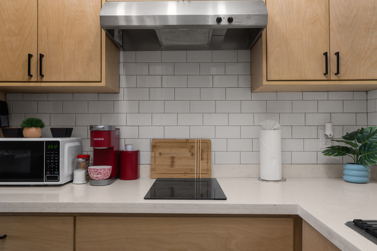 Kitchenette with cooktop, microwave, coffee maker, and counter space for simple meals.
