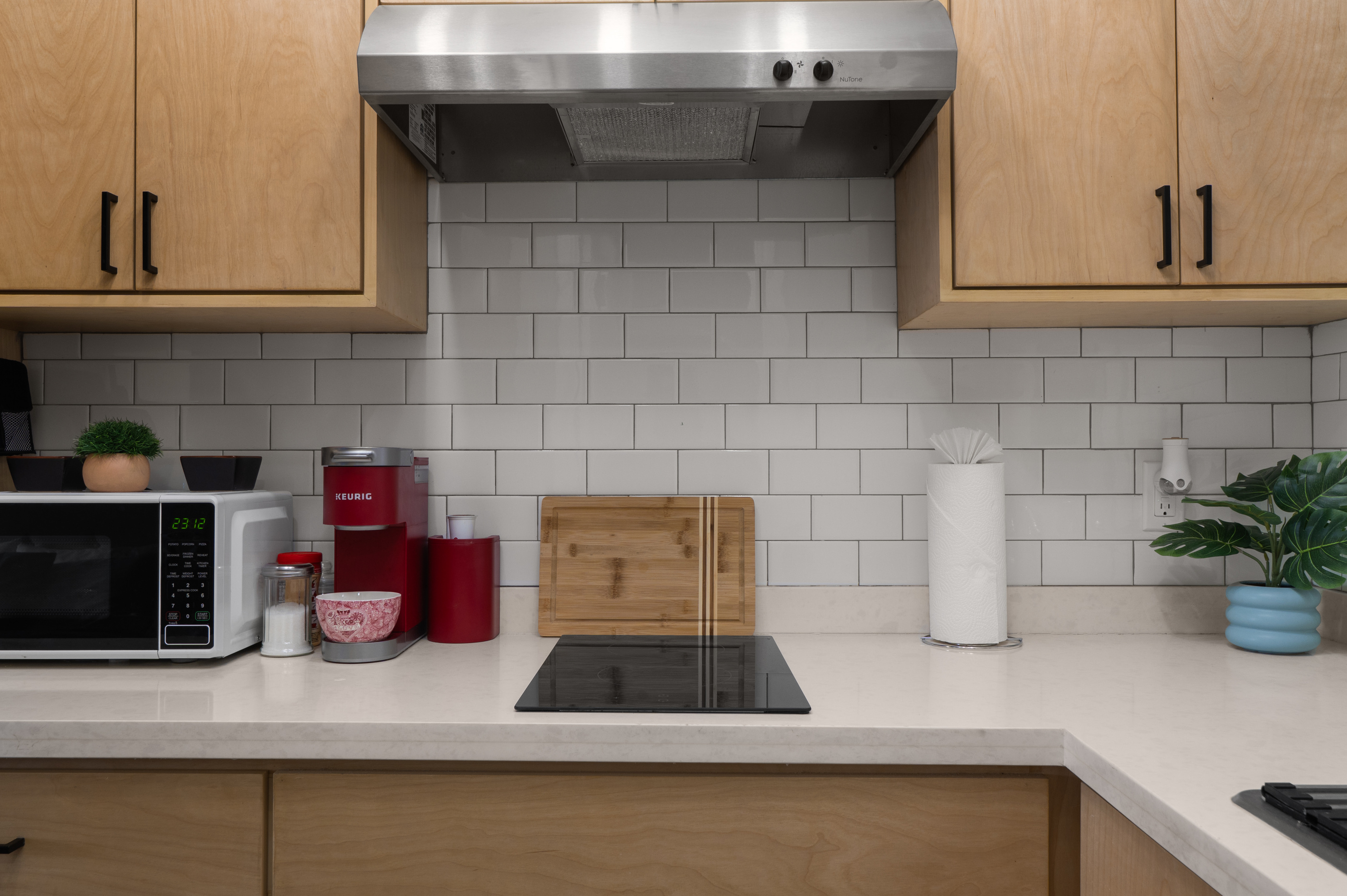 Kitchenette with cooktop, microwave, coffee maker, and counter space for simple meals.
