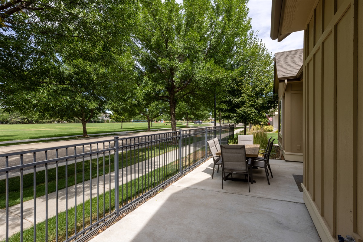 Private patio with peaceful park and walkway views.