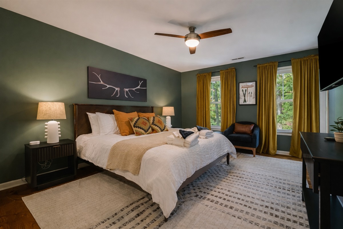 A warm and inviting primary suite — unwind with soft lighting and cozy textures.