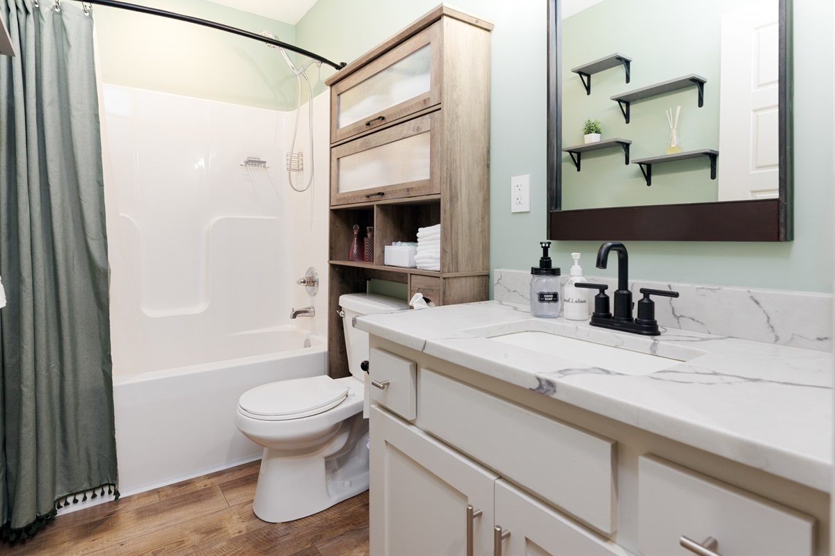 Full hall bathroom with tub/shower combination, conveniently shared by the second and third bedrooms.