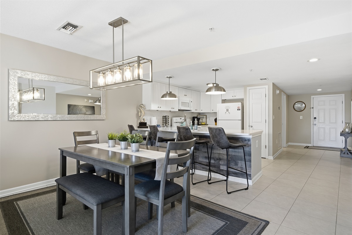 There is seating for four at the kitchen counter and an additional six around the dining table