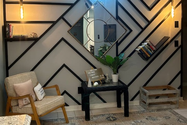 Enjoy the reflection of the bright neon sign as you pick a book off the shelf to enjoy while the nice ocean breeze blows through the open french doors, to make the inside feel more like an extension to the outside.