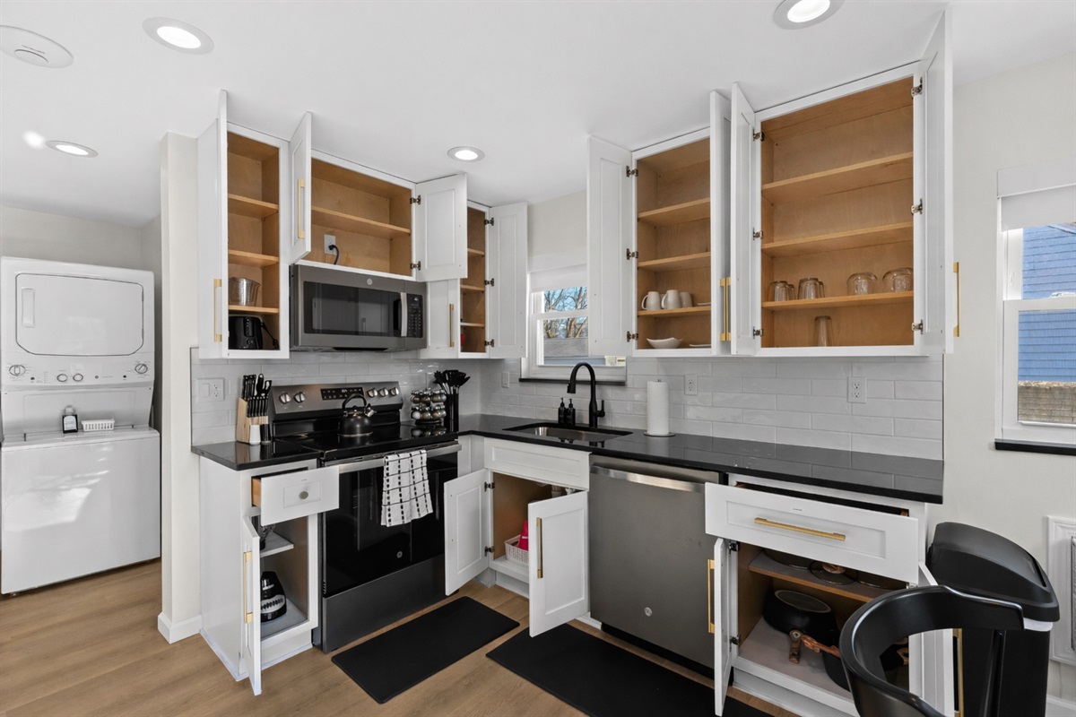 Fully stocked kitchen with ample cabinet space, modern appliances, and thoughtful organization—everything you need for easy cooking and extended stays.
