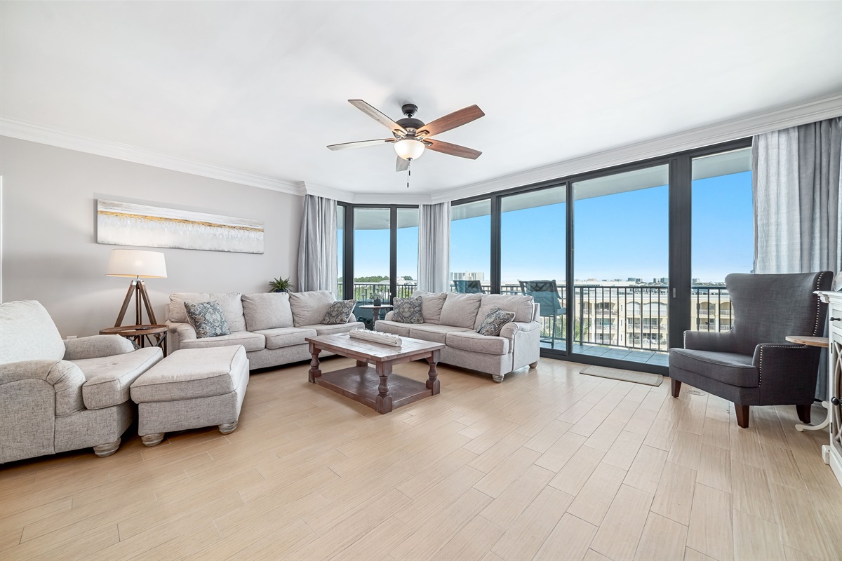 Spacious and inviting living area with floor-to-ceiling windows showcasing breathtaking panoramic views. This open-concept design seamlessly blends comfort and style, creating the perfect space for relaxation and entertainment.