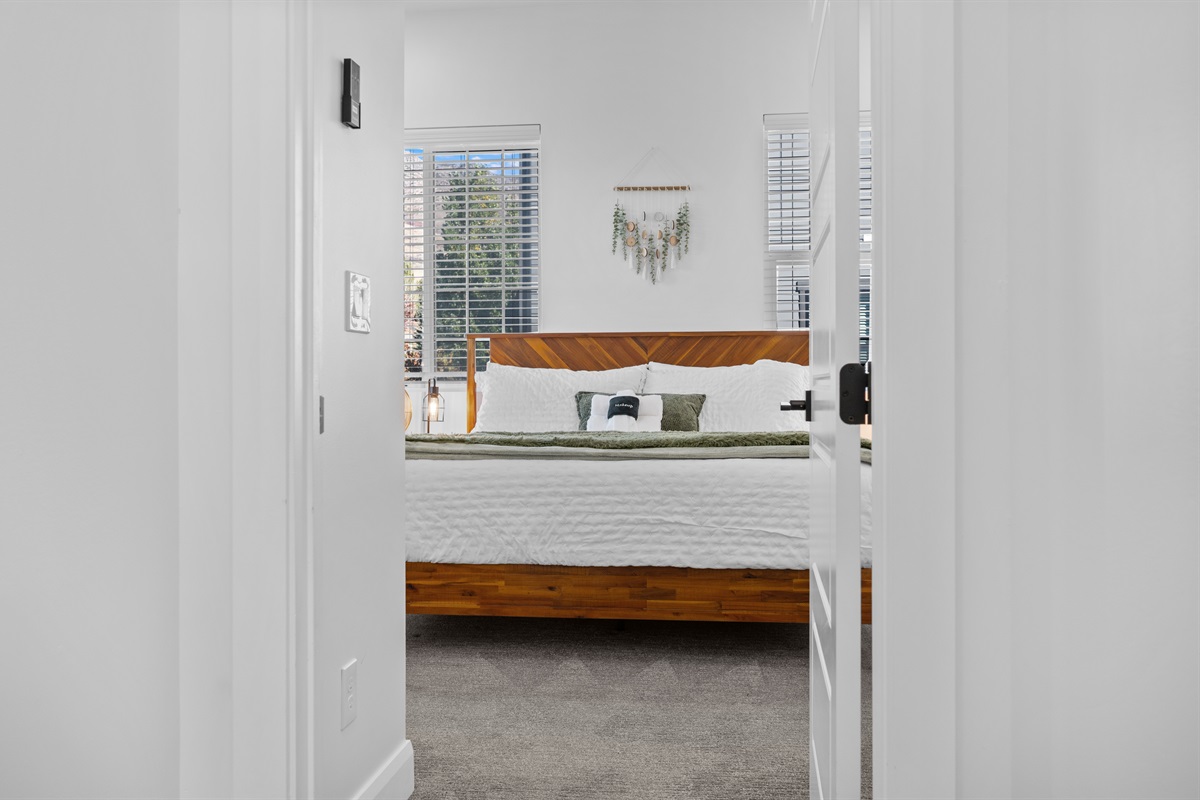 Entry to the spacious upstairs primary suite with natural light.
