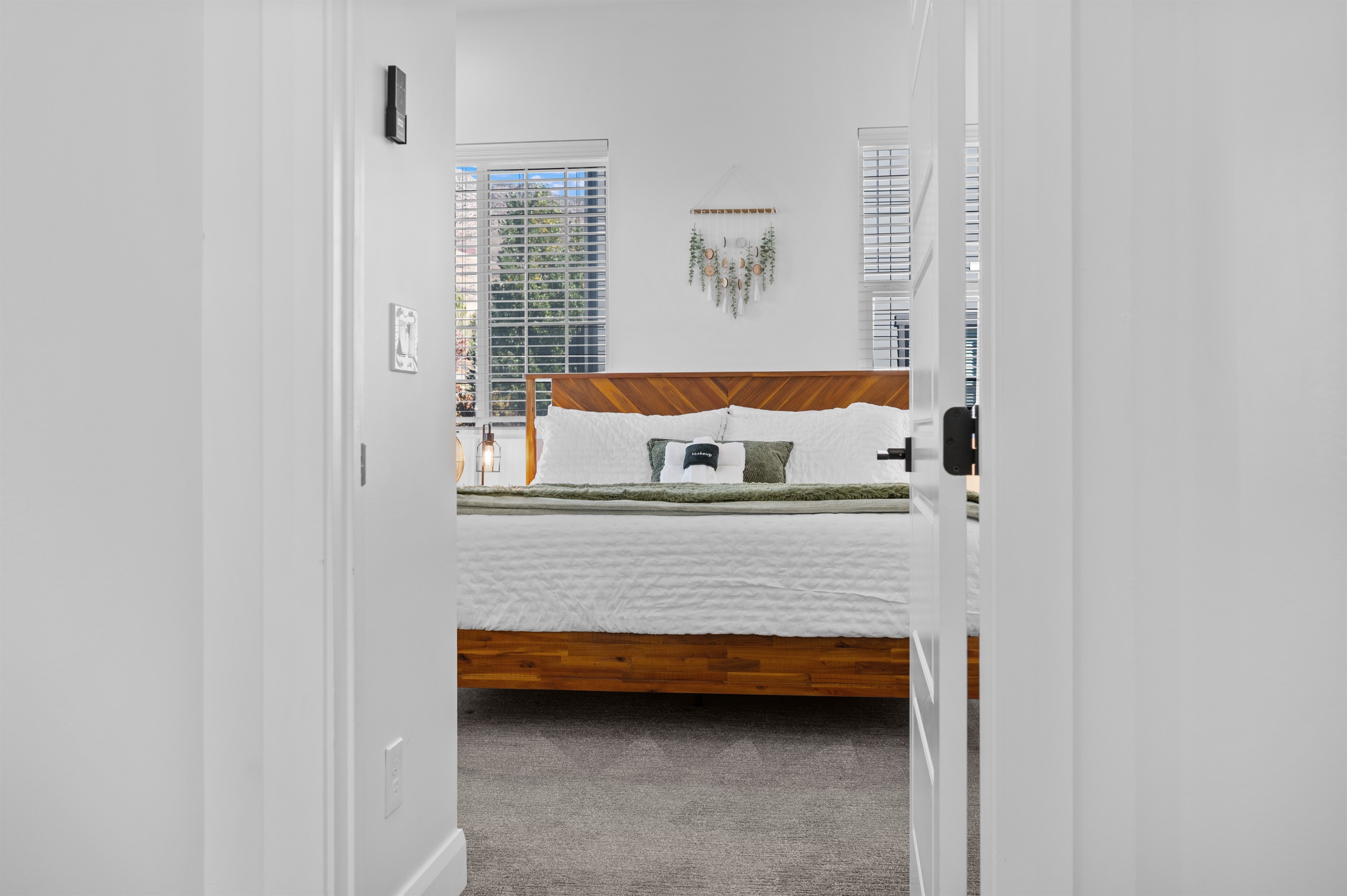 Entry to the spacious upstairs primary suite with natural light.