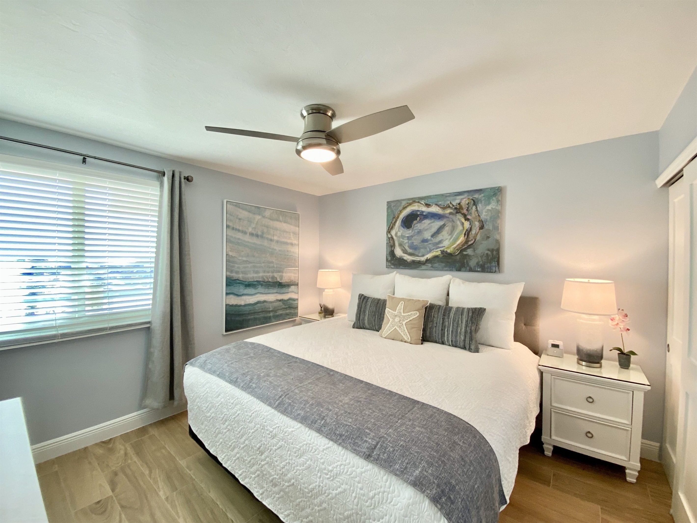 King Bed & a Large 55” flat screen TV on wall. Custom built-in closet w/ drawers