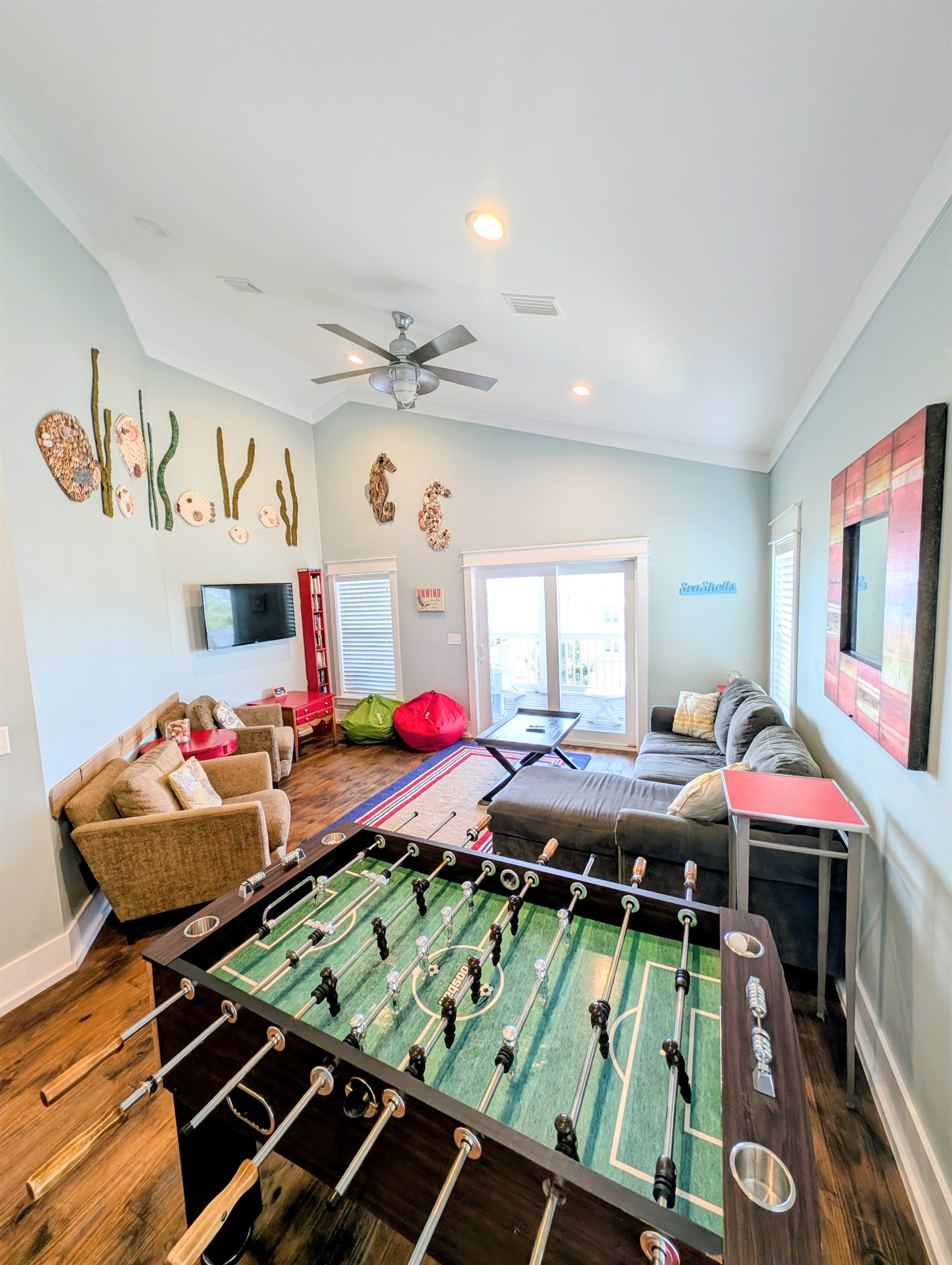 Third floor game room includes a foosball table, dozens of board games and puzzles and a Pac-Man arcade game.