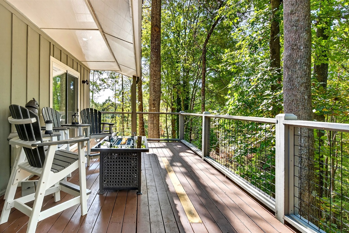 Outdoor seating by the fire table on the upper-level deck.
