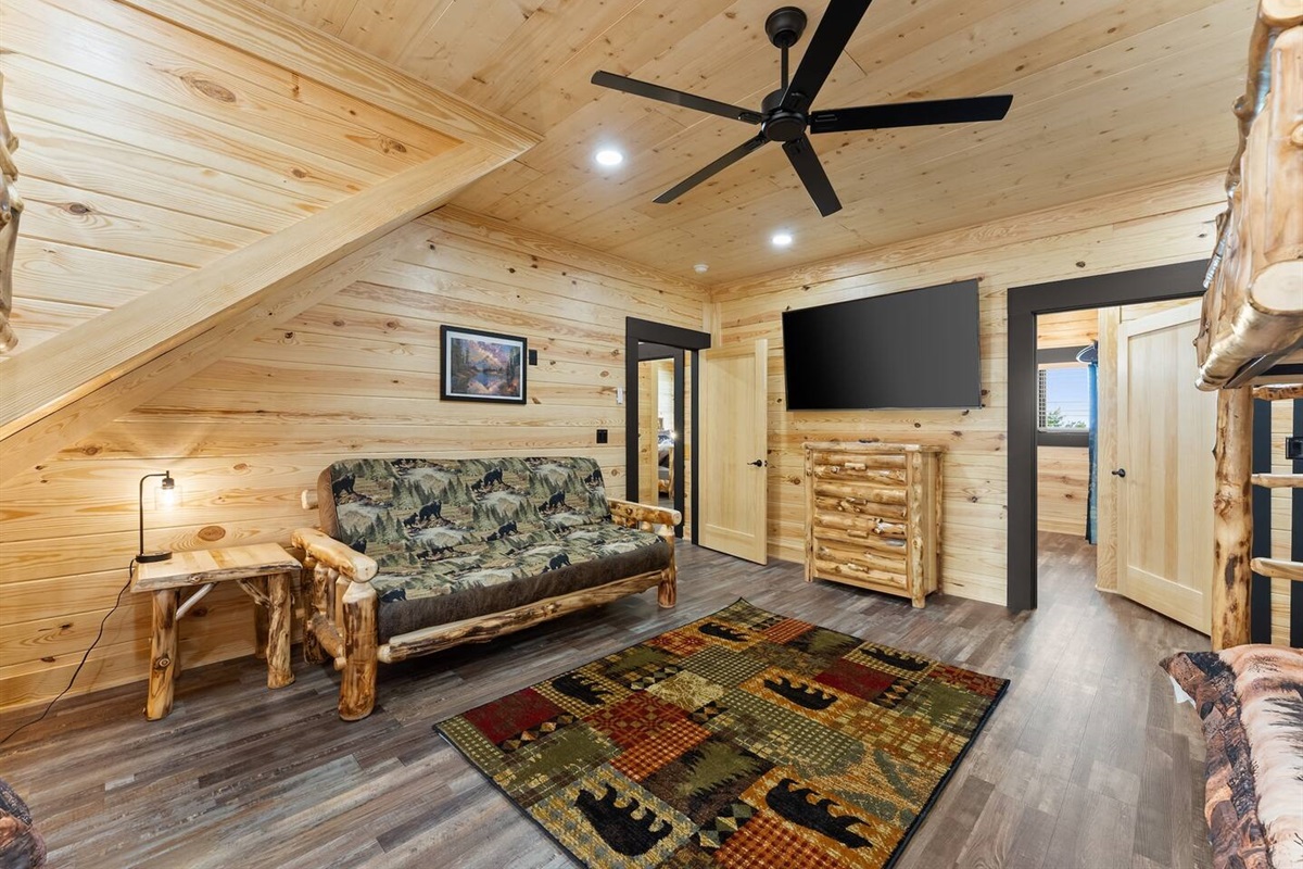 Complete with a large flat-screen TV, rustic dresser, and playful decor, Bedroom 4 keeps guests of all ages entertained and relaxed.