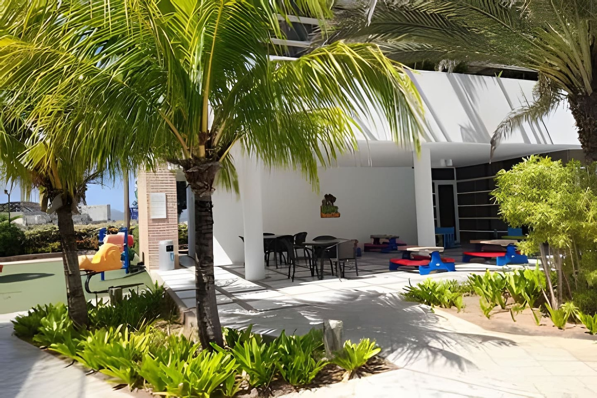 Take a moment in this vibrant outdoor seating area, surrounded by lush greenery.