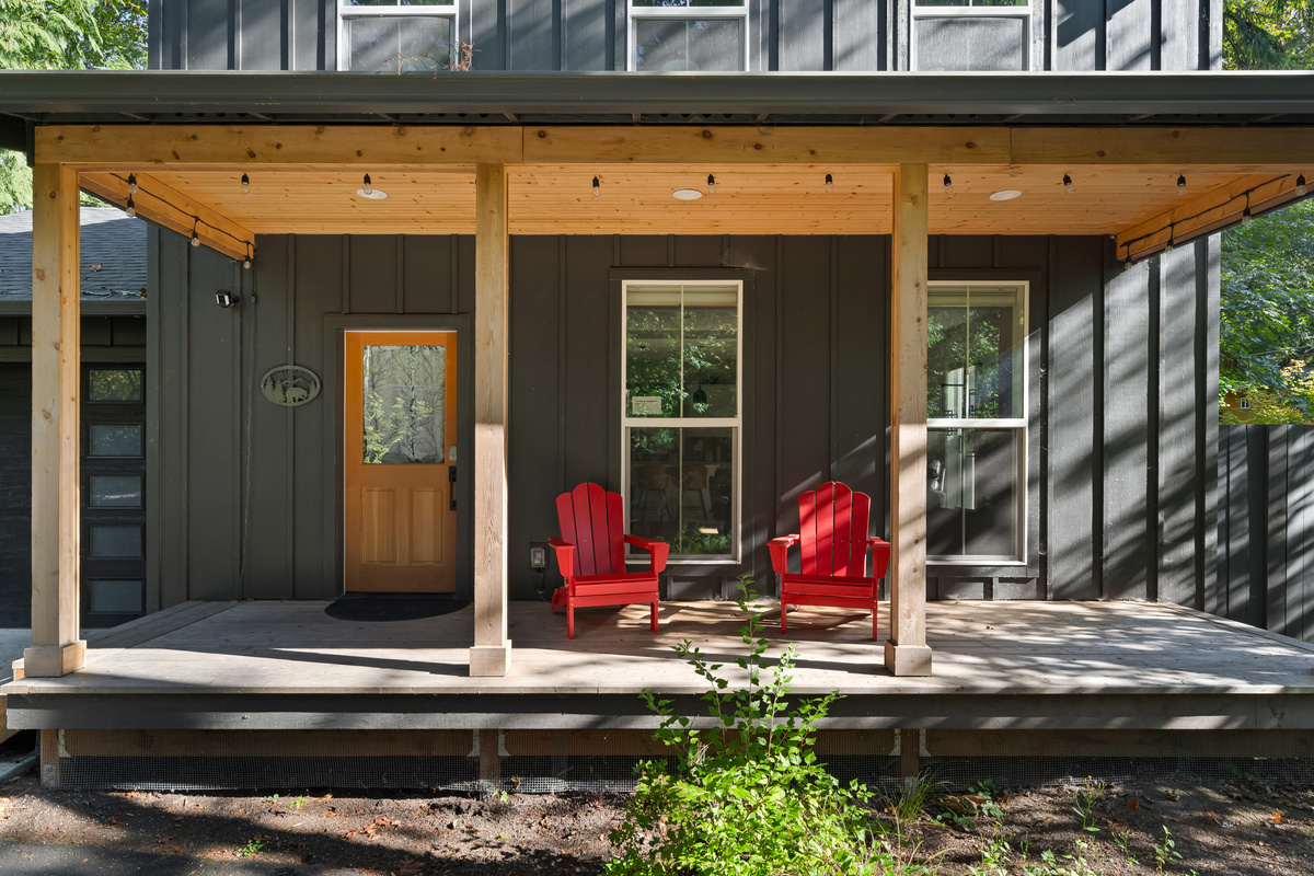Morning coffee spot: covered porch seating just steps from the forest.