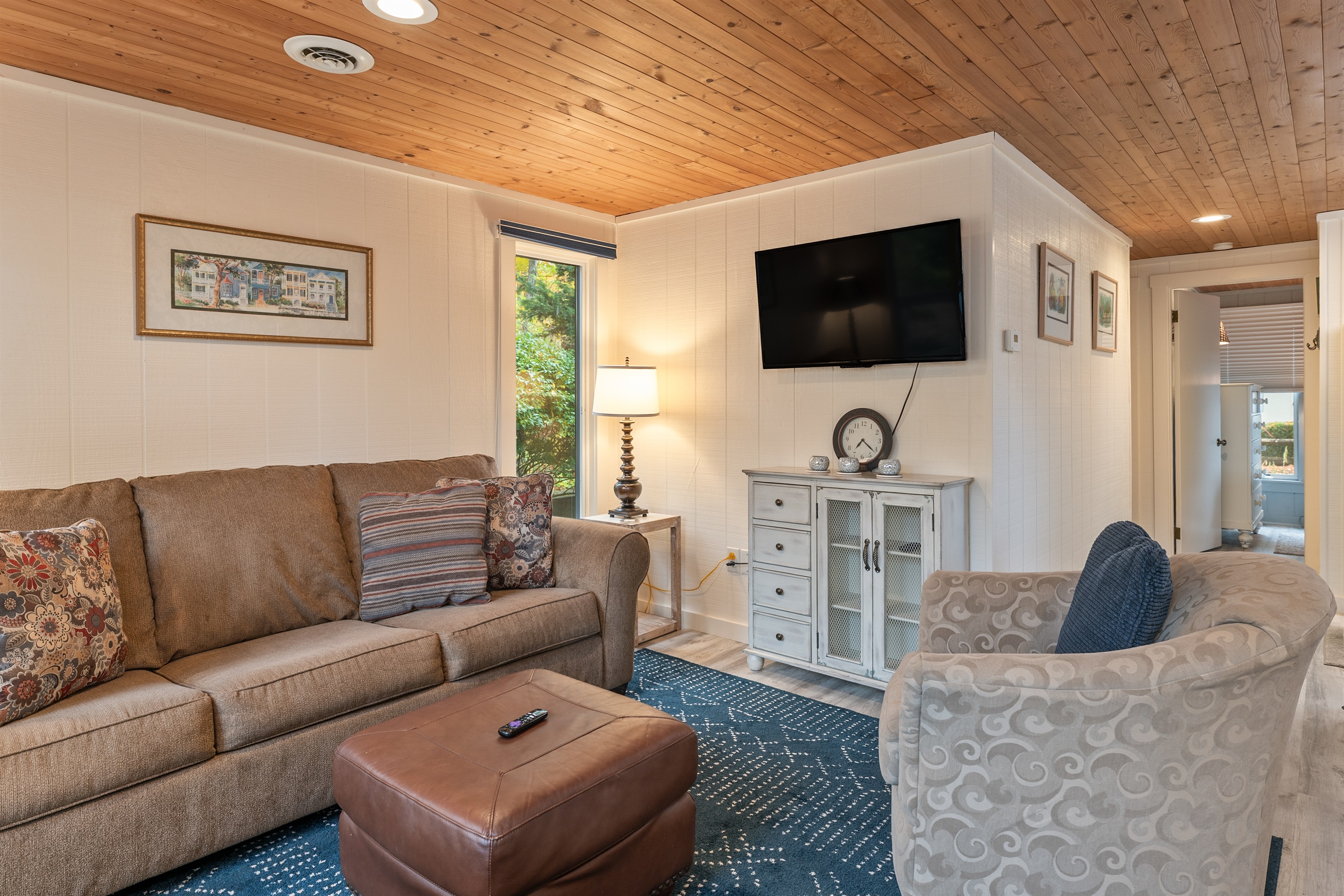 Spacious living room with cozy seating and a smart TV for entertainment.