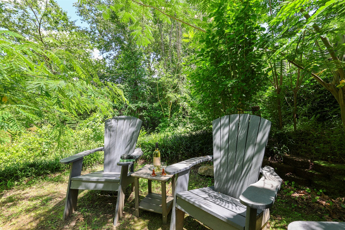 Fire pit area behind the house with river views
