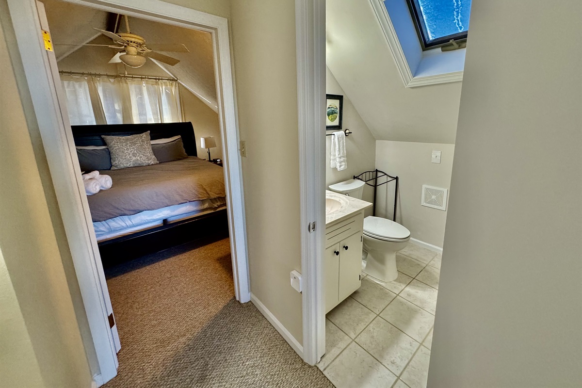 The Top Floor King Bedroom has 2 nightstands, charging outlets with USB ports, luggage racks, a closet to hang clothes, a chair to sit and rest, as well as a Roku Smart TV.