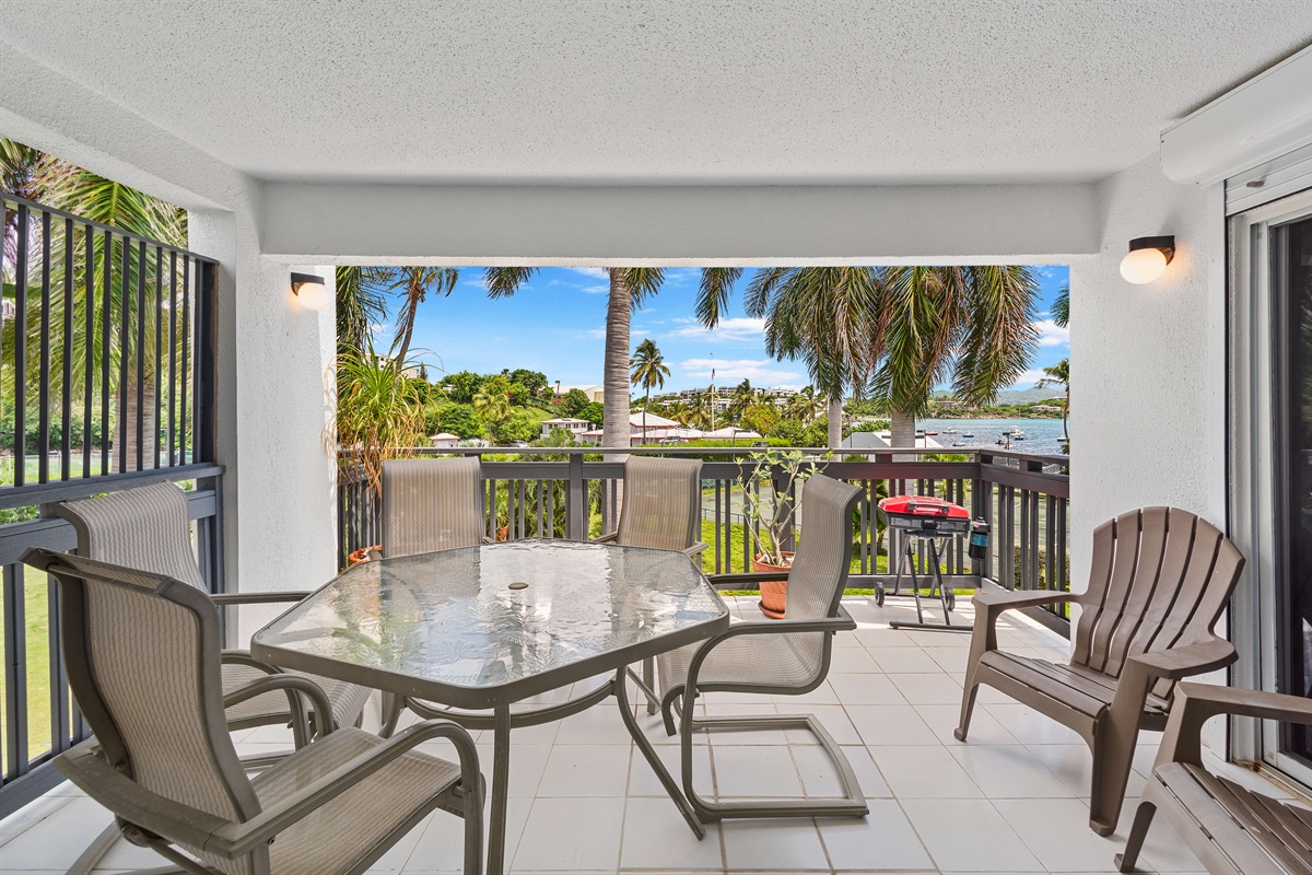 Covered porch with water views and comfortable seating