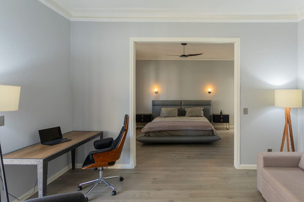 Beautiful primary bedroom with pull out sofa in the sitting room.  Terrific desk and seating.  (Bedroom 1).